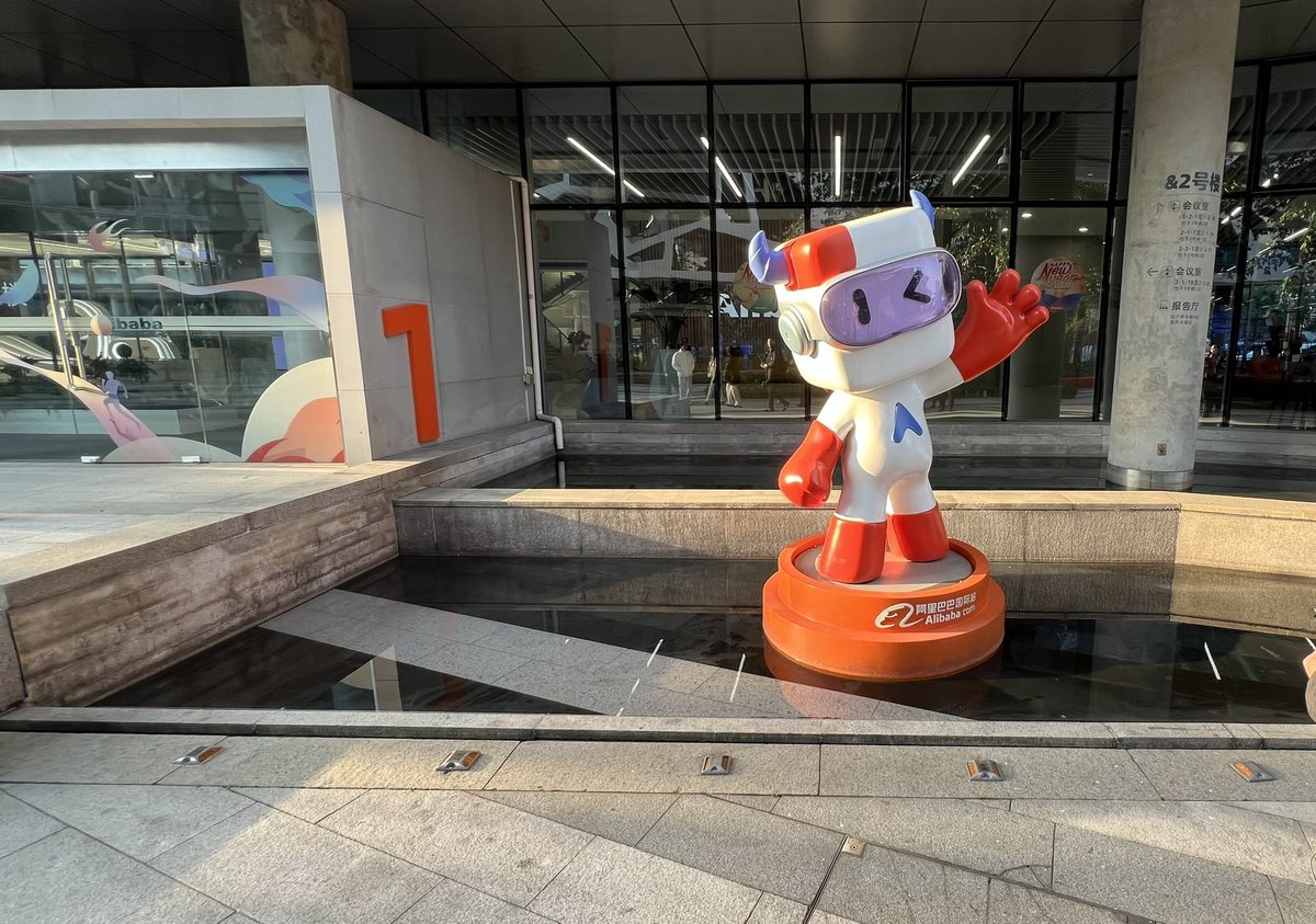 アリババ杭州本社の敷地に立つ、ゴーグルをつけた白い牛のキャラクター像。台座にAlibaba.comと書かれている